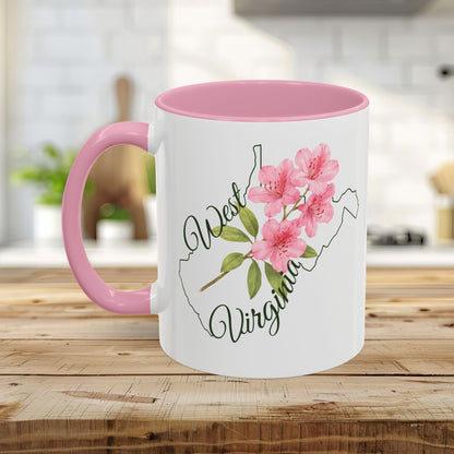 White ceramic mug with pink handle and interior, featuring a watercolor West Virginia rhododendron design.