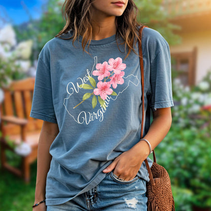 Garment-dyed blue t-shirt with a watercolor rhododendron inside a West Virginia state outline.