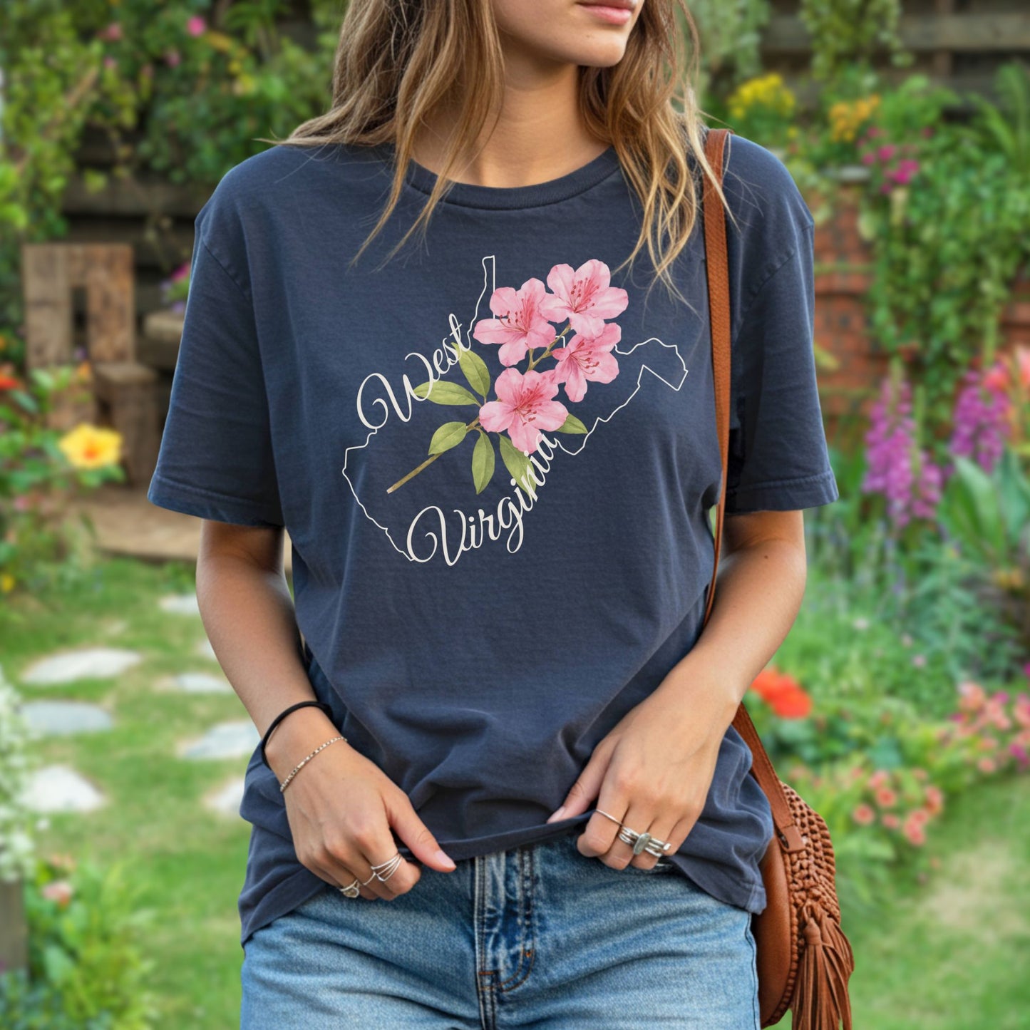Garment-dyed navy t-shirt with a watercolor rhododendron inside a West Virginia state outline.