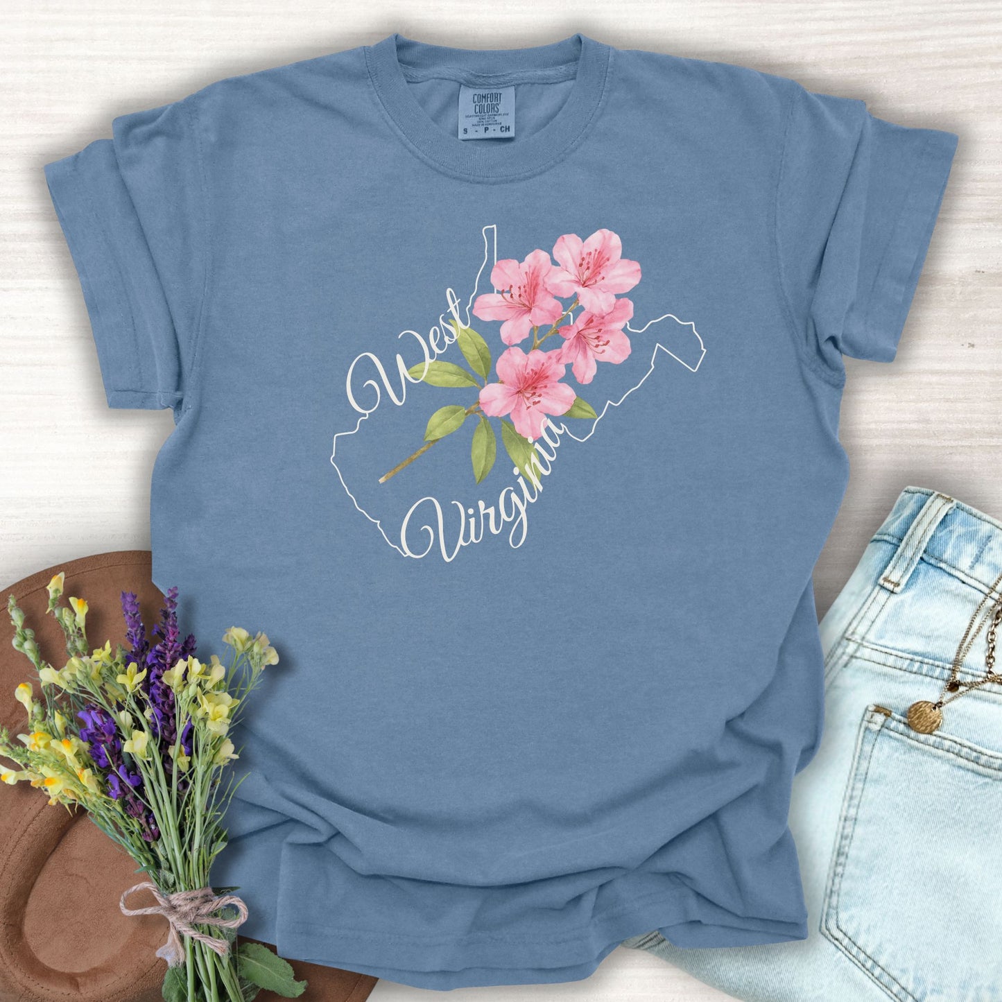 Blue Jean West Virginia t-shirt with a watercolor rhododendron inside the state outline.