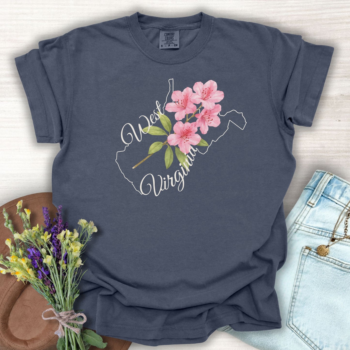 Denim S t-shirt with West Virginia outline and watercolor rhododendron, styled with jeans and flowers.