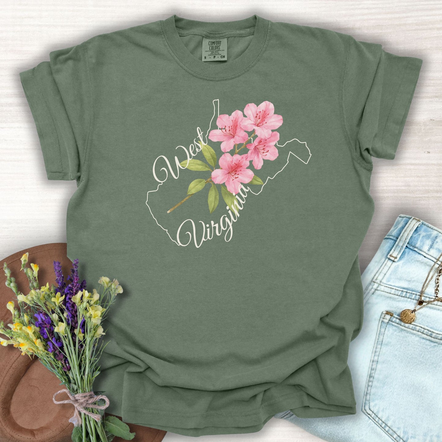 Moss green West Virginia t-shirt with a watercolor rhododendron inside the state outline.