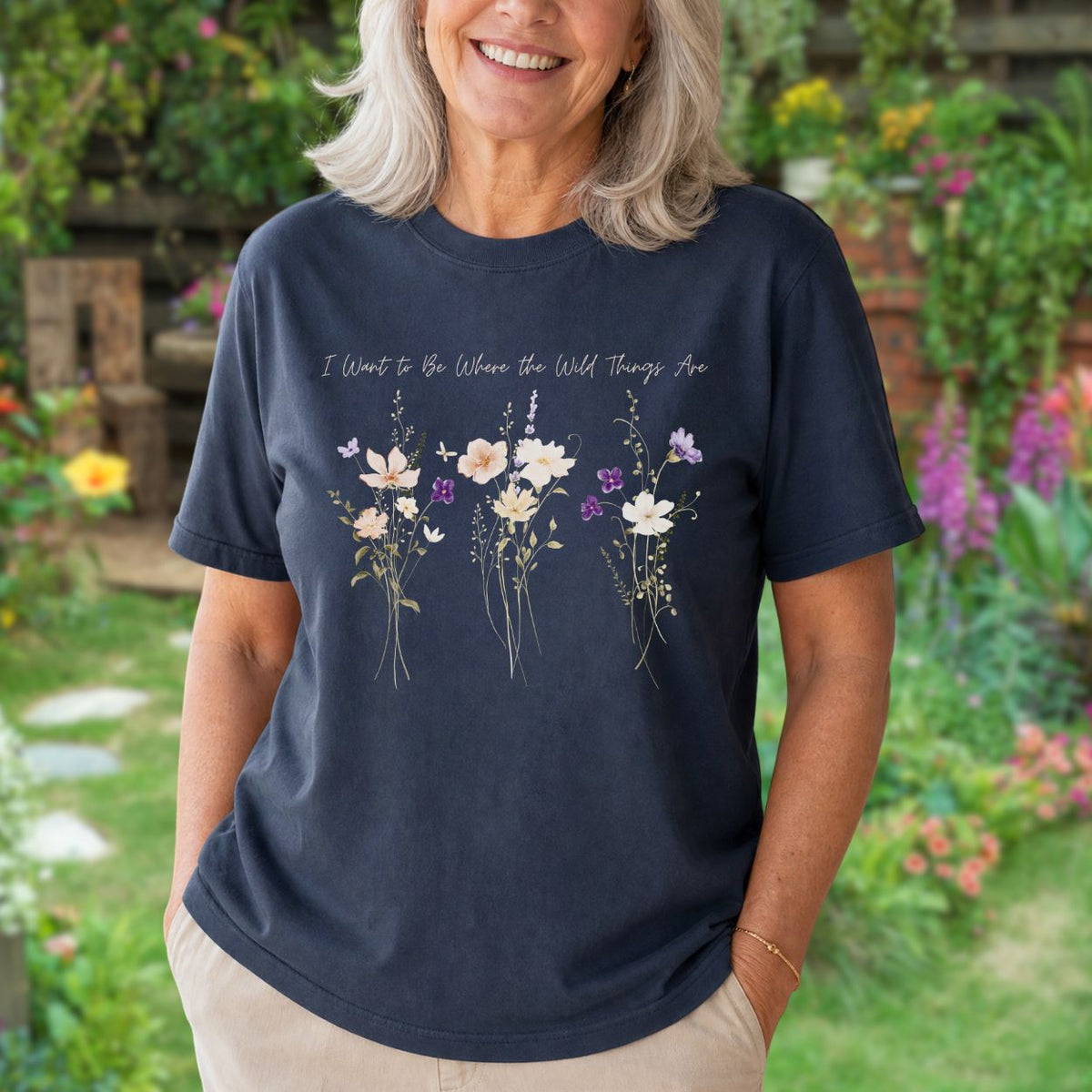 Relaxed-fit navy garment-dyed cotton t-shirt featuring watercolor purple wildflowers and hand-lettered text on the chest.