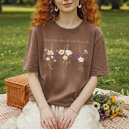 Brown garment-dyed cotton t-shirt featuring watercolor wildflowers and the text I Want to Be Where the Wild Things Are.