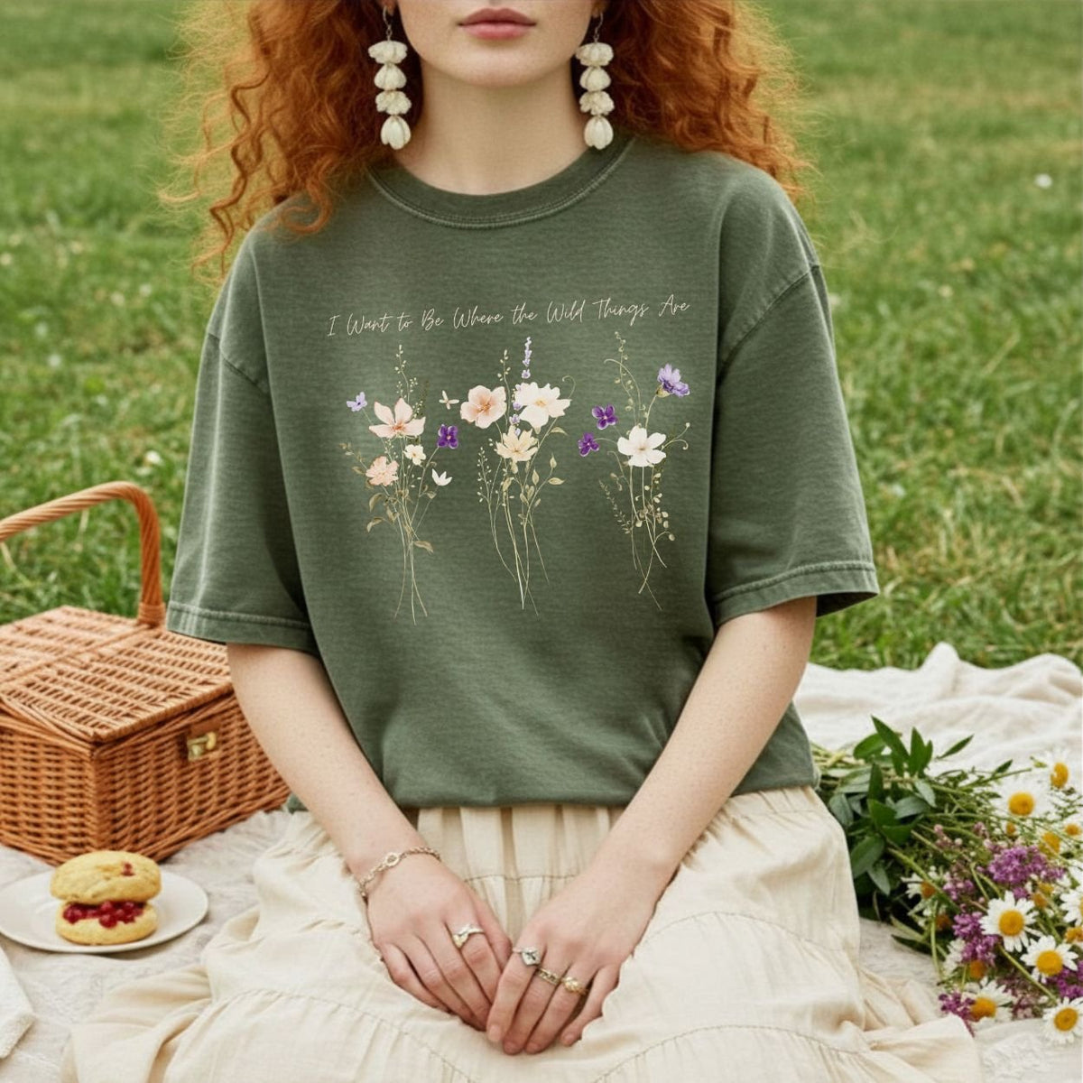 Olive green garment-dyed cotton t-shirt featuring delicate watercolor wildflowers and the text I Want to Be Where the Wild Things Are.