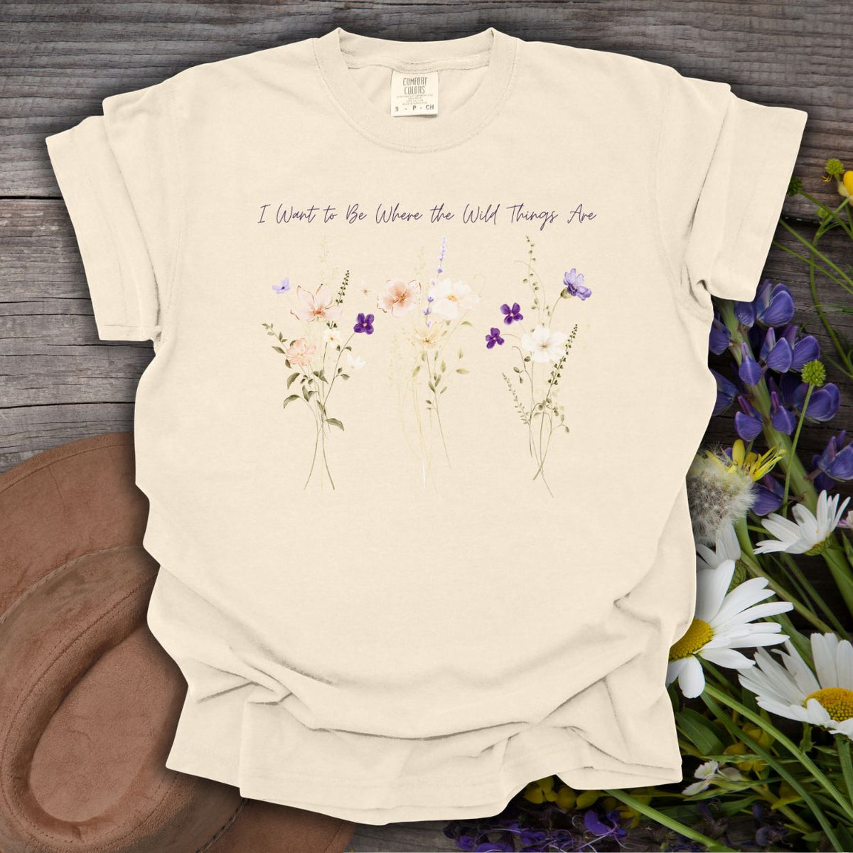 Ivory garment-dyed cotton t-shirt featuring watercolor purple wildflowers and the text I Want to Be Where the Wild Things Are.