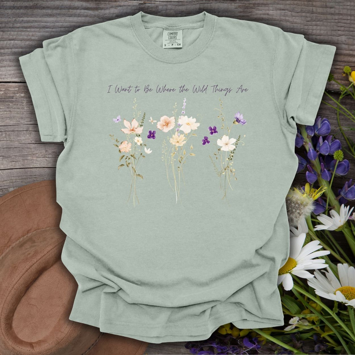 Bay-colored garment-dyed cotton t-shirt in size small, featuring watercolor wildflowers and hand-lettered text.