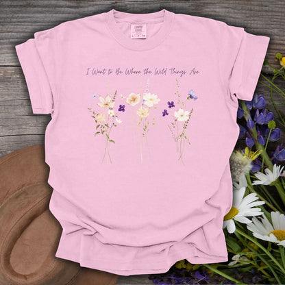 Blossom pink garment-dyed cotton t-shirt featuring watercolor wildflowers and the text I Want to Be Where the Wild Things Are.