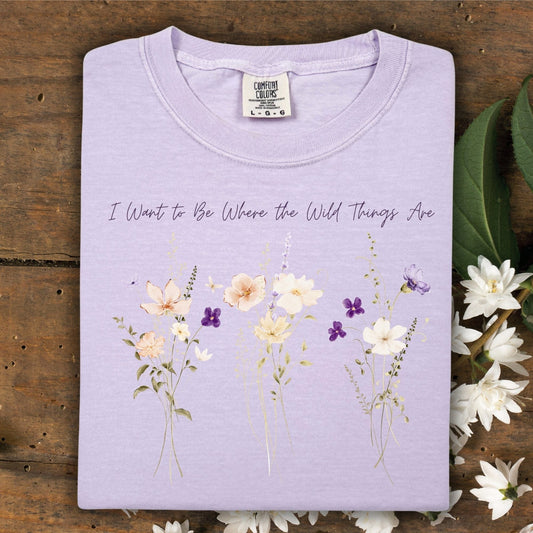 Orchid Comfort Colors t-shirt with "I Want to Be Where the Wild Things Are" and cream/purple wildflowers.