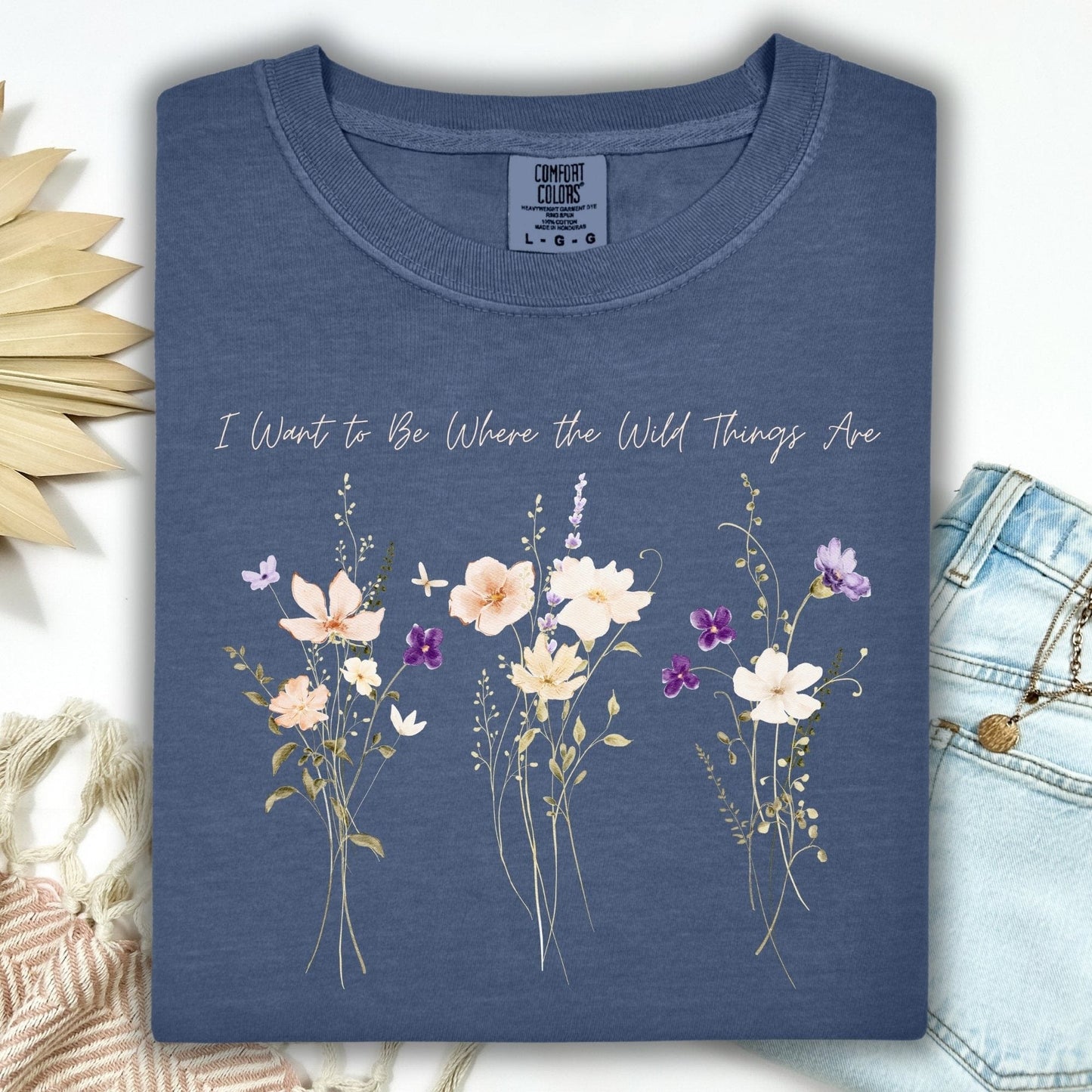 Denim Comfort Colors t-shirt with cream and purple wildflowers and "I Want to Be Where the Wild Things Are" text.