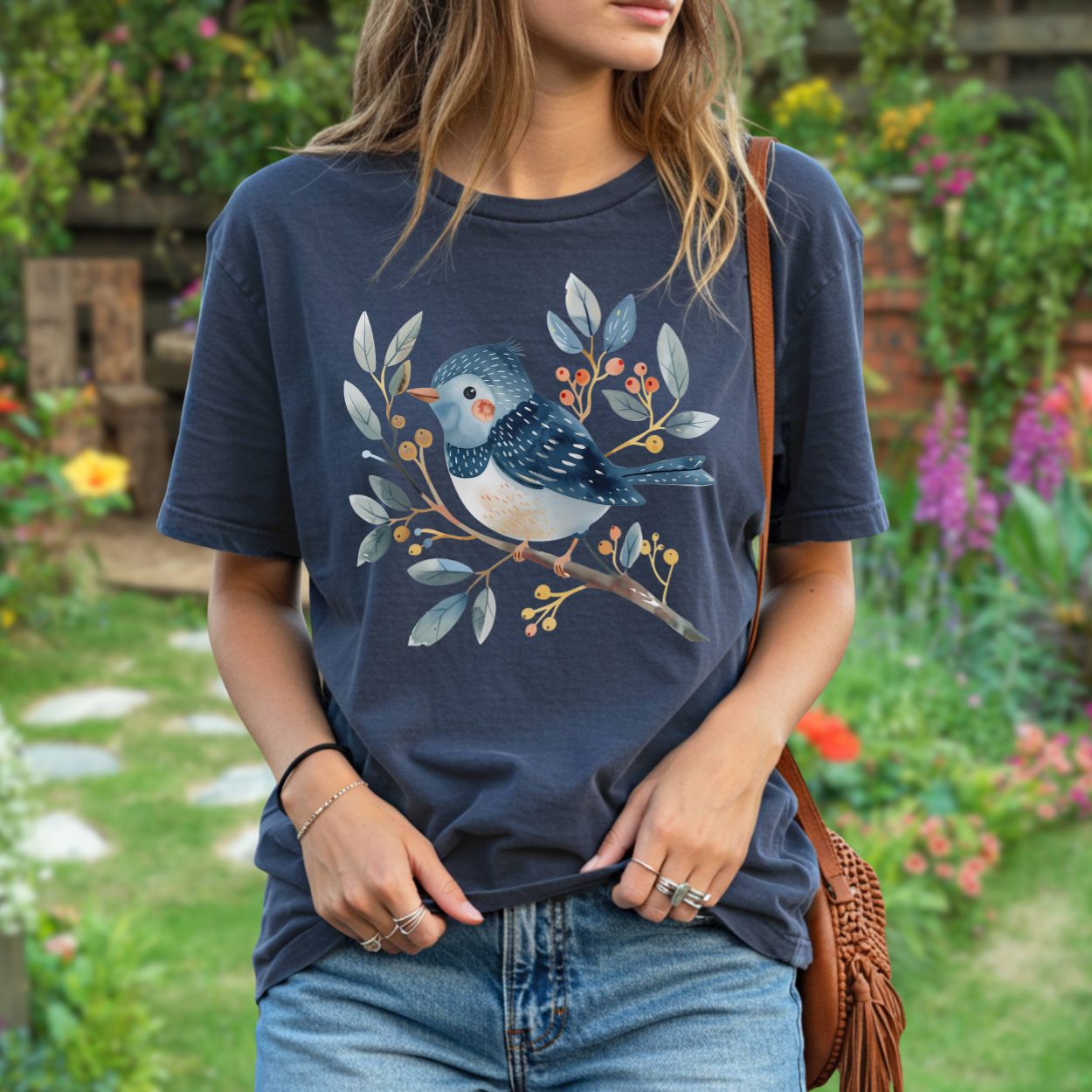 Whimsical bluebird on a leafy branch design on a relaxed-fit, garment-dyed navy t-shirt.