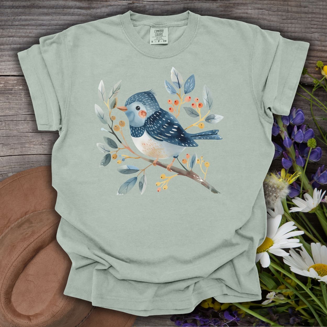 Bay S T-shirt with a whimsical bluebird on a branch, painted in watercolor style.