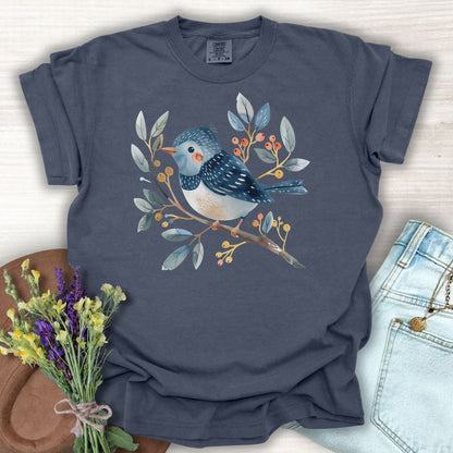 Denim S t-shirt with a whimsical bluebird on a branch, painted in watercolor blues, reds, and oranges.