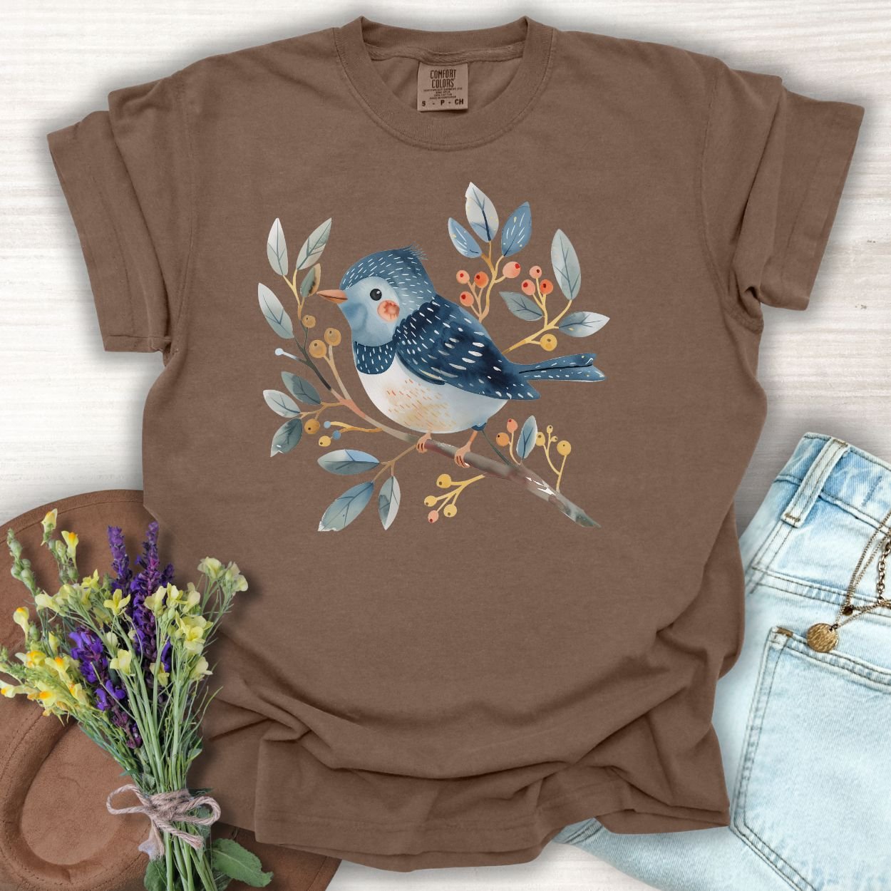 Espresso S t-shirt with a whimsical bluebird on a branch, featuring watercolor leaves and berries.