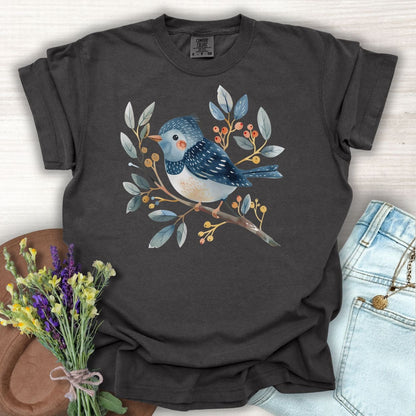 Pepper S T-shirt with a whimsical bluebird on a branch, painted in watercolor style.