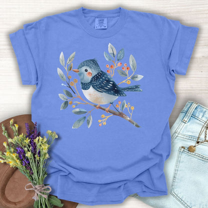 Periwinkle S t-shirt with a whimsical bluebird on a leafy branch with red and orange berries.