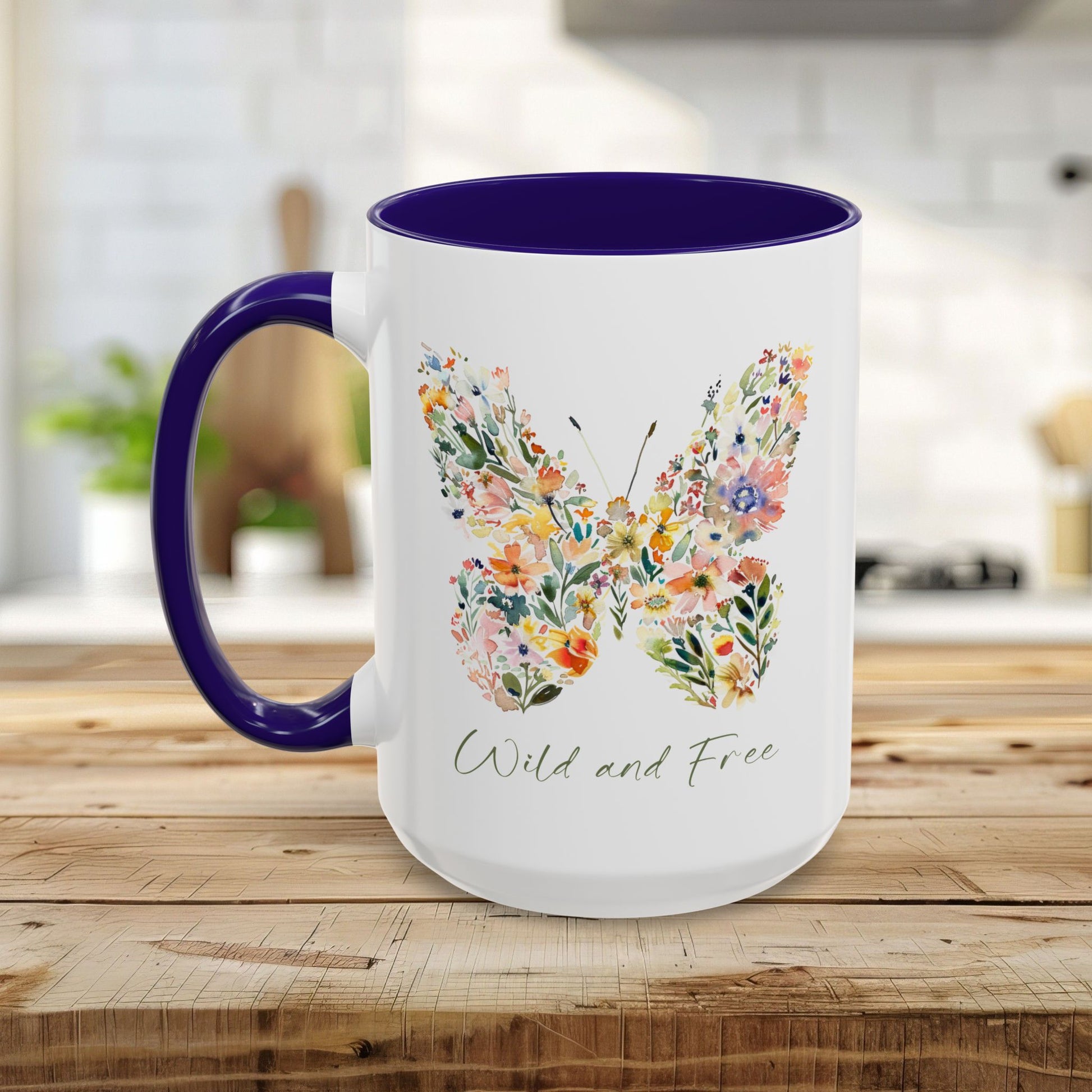 White ceramic mug with a purple handle and interior, featuring a watercolor floral butterfly and "Wild and Free" text.