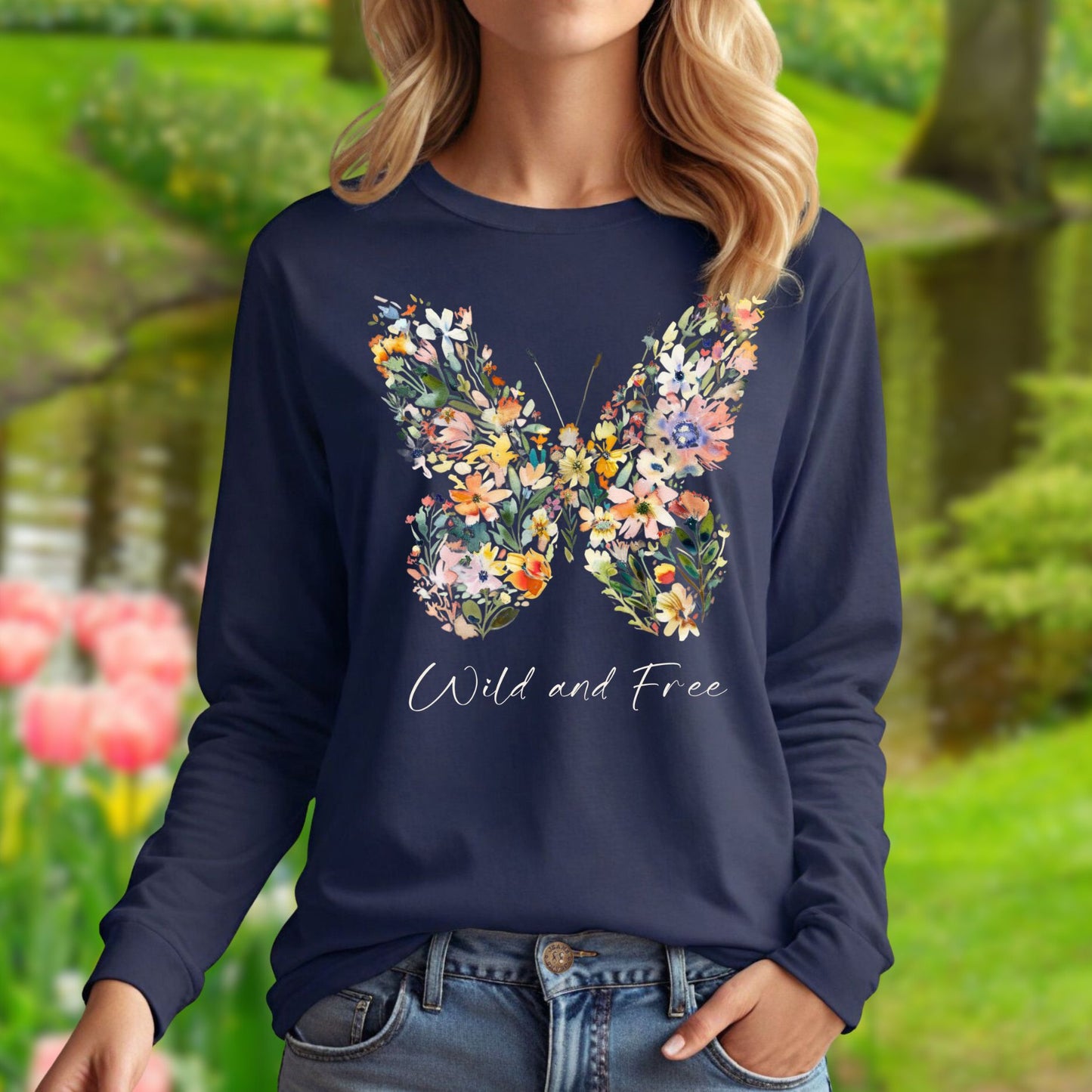 Navy long-sleeve tee with a colorful wildflower butterfly print and "Wild and Free" text.
