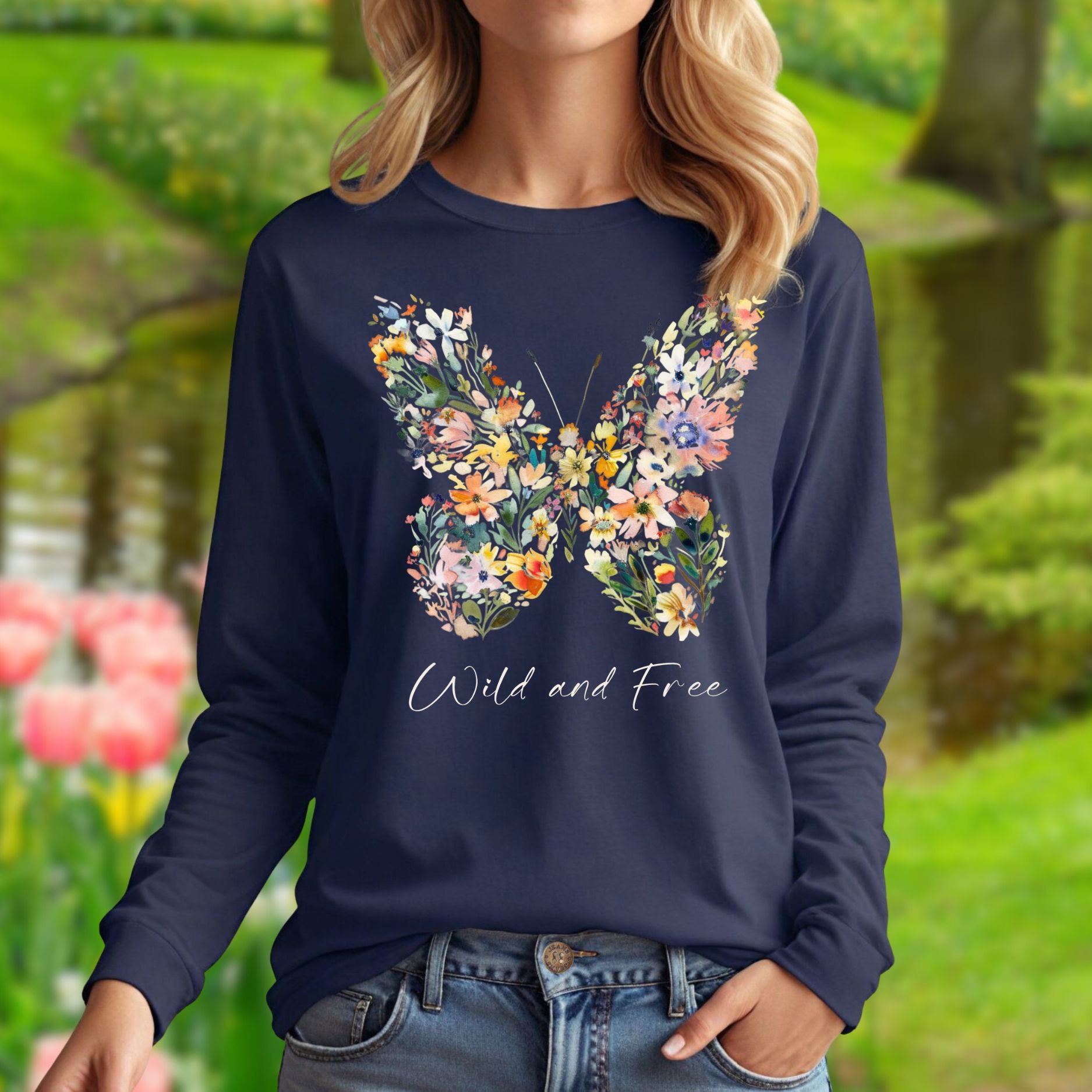 Navy long-sleeve tee with a colorful wildflower butterfly print and "Wild and Free" text.