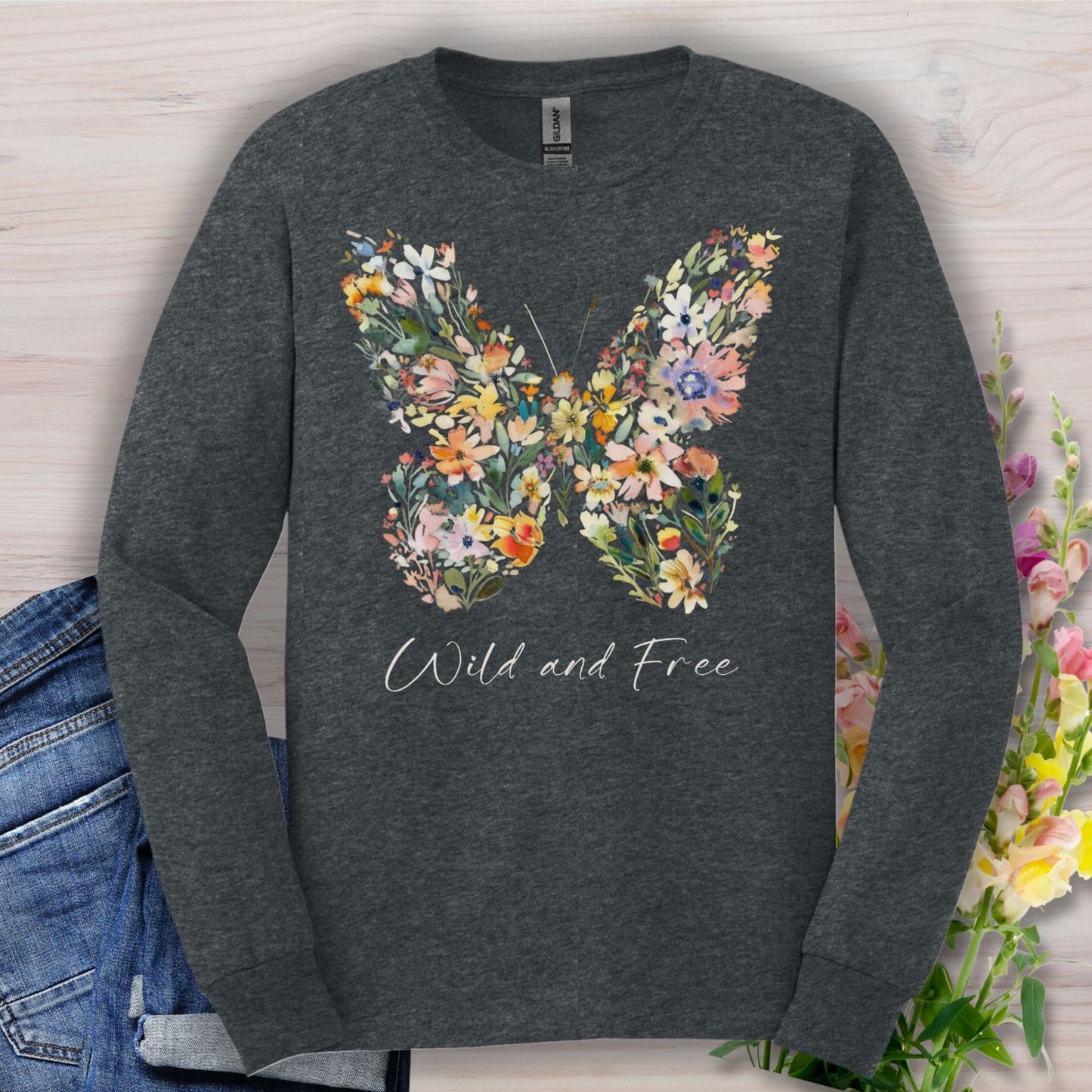 Heather charcoal long-sleeve tee with a colorful wildflower butterfly and "Wild and Free" text.
