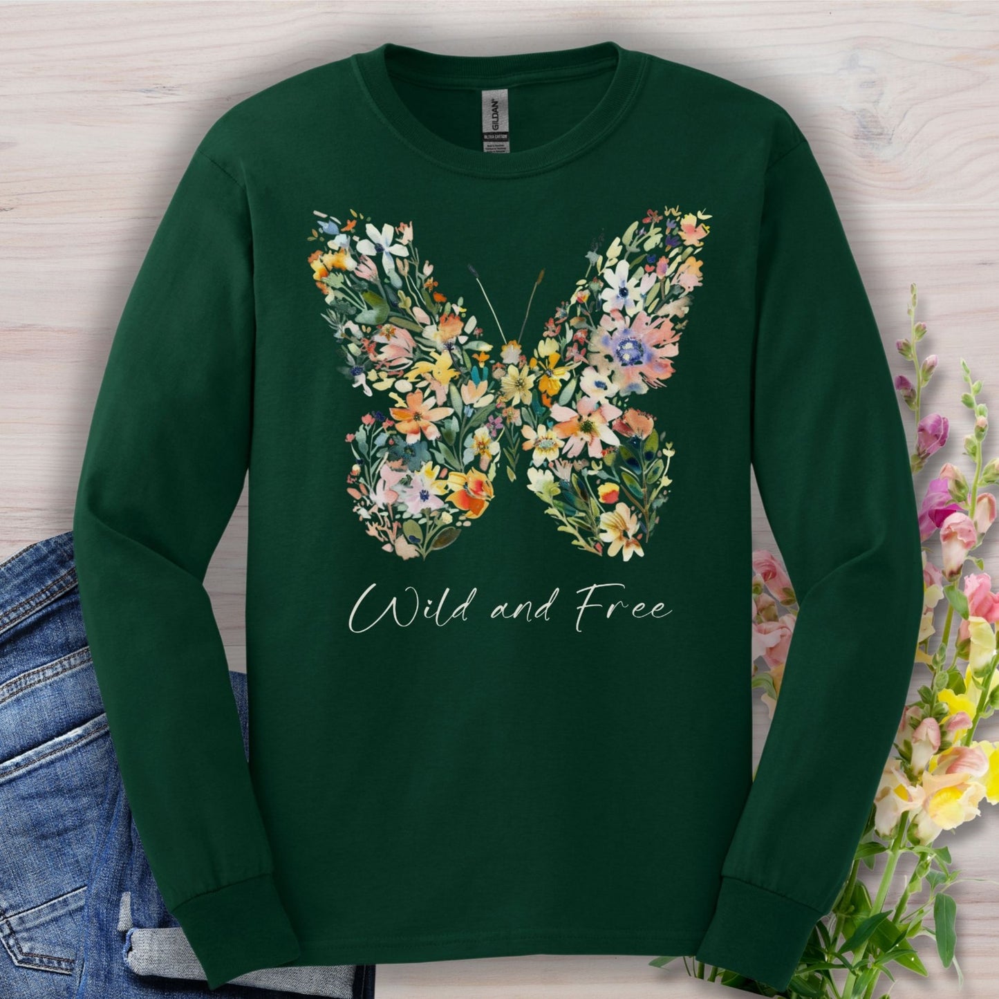 Forest Green long-sleeve tee with a colorful wildflower butterfly and "Wild and Free" text.