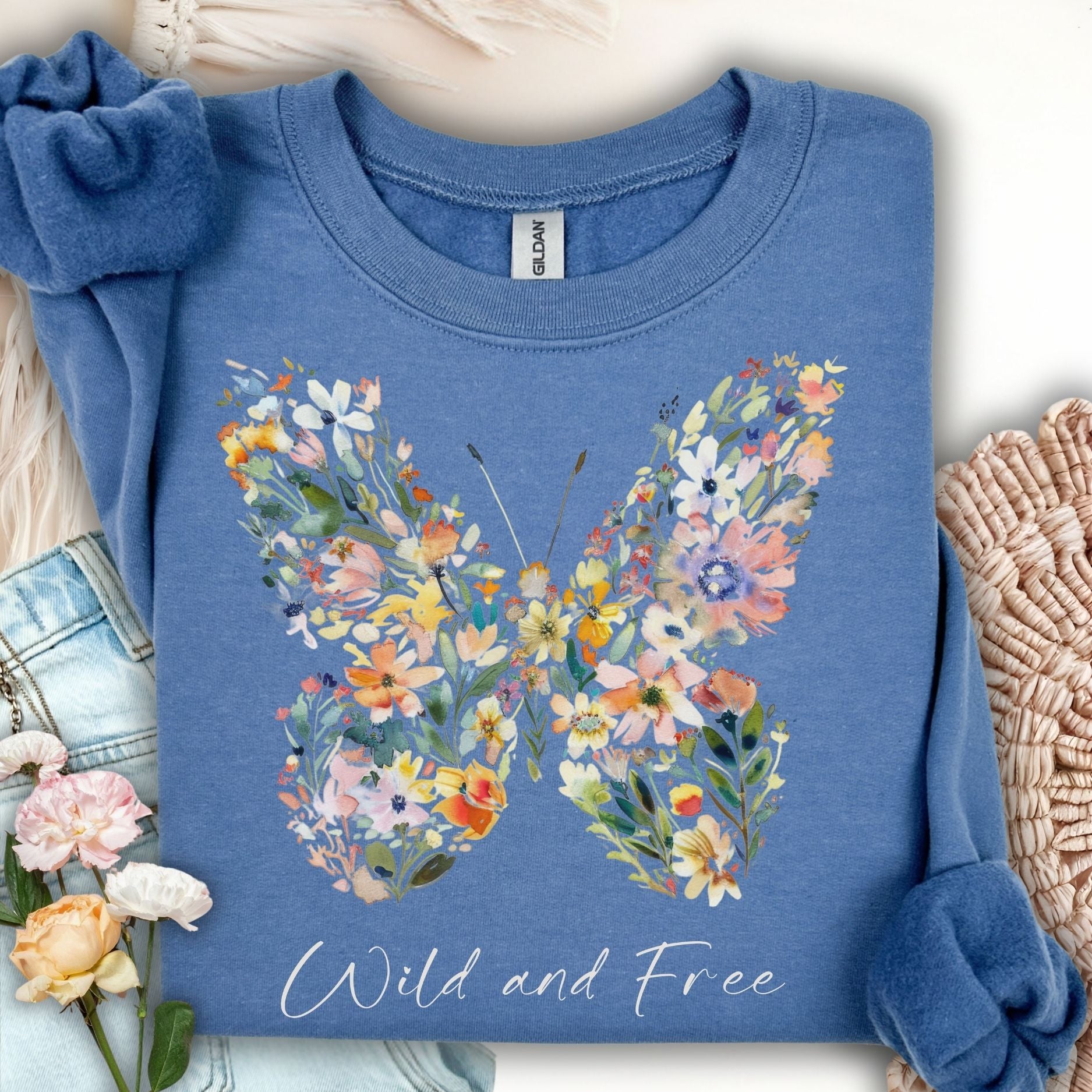 Indigo Blue S sweatshirt with a painterly wildflower butterfly and "Wild and Free" script.