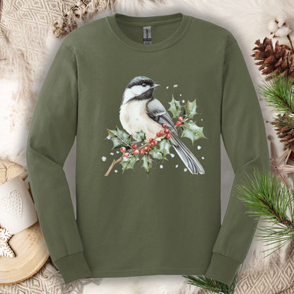 Olive green long sleeve tee with a watercolor chickadee on a snow-dusted holly branch with red berries.
