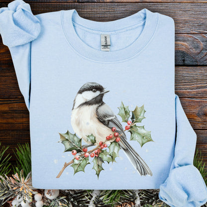Light blue cotton-polyester sweatshirt with a watercolor chickadee on a frosted holly branch design.