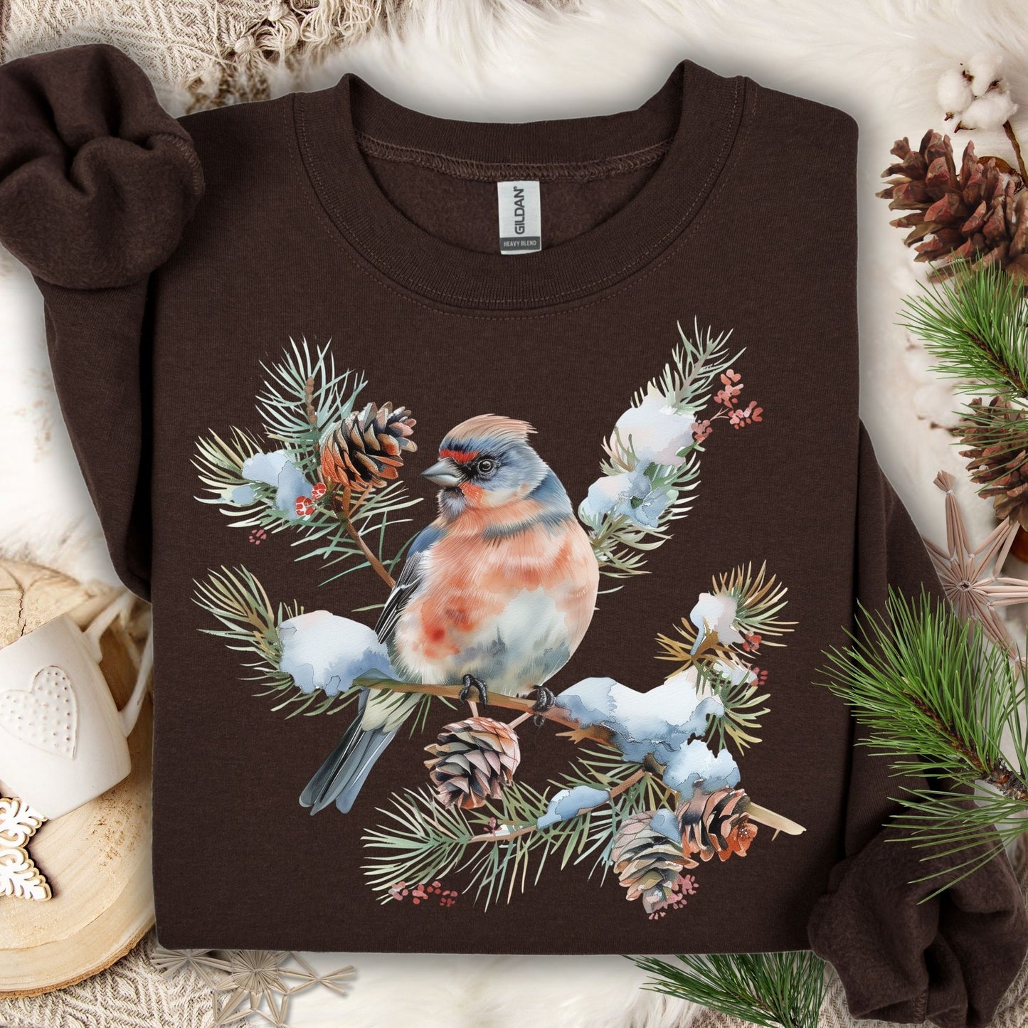 Dark Chocolate sweatshirt with a winter bird on a snowy evergreen branch, pinecones, and berries design.