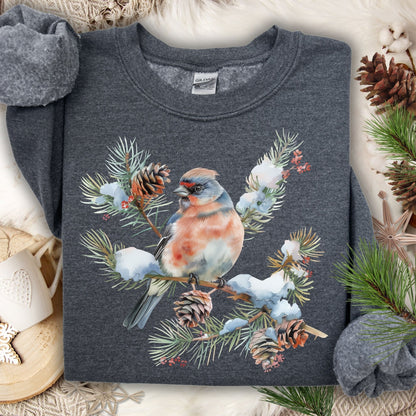 Dark Heather S sweatshirt with a crested bird on a snowy evergreen branch, pinecones, and berries.
