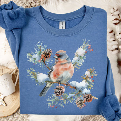 Indigo blue sweatshirt with a crested songbird on a snowy evergreen branch design.