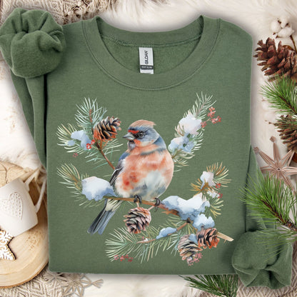 Military Green sweatshirt with a crested songbird on a snowy evergreen branch with pinecones and berries.