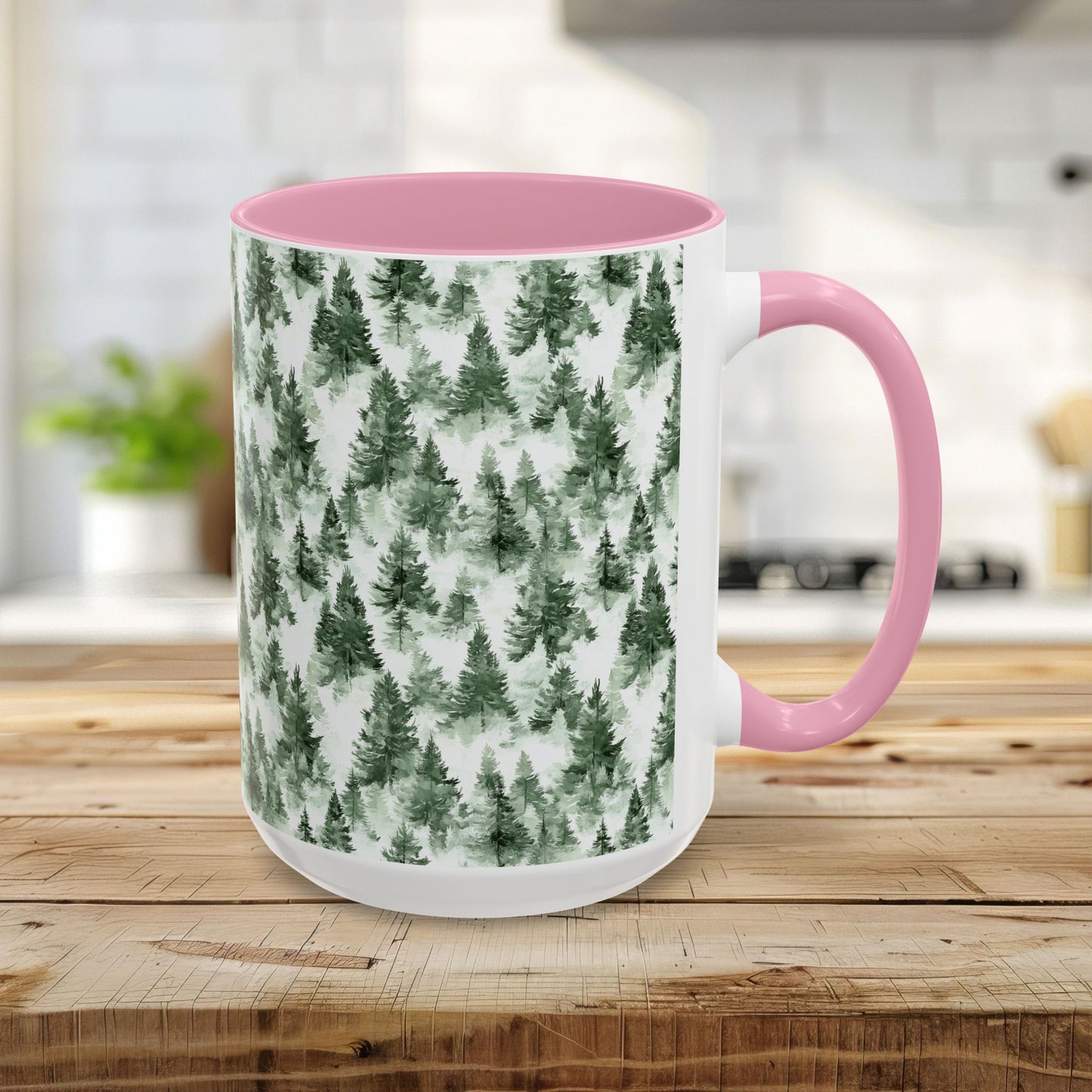 White ceramic mug with a pink handle and interior, featuring a watercolor evergreen forest pattern.