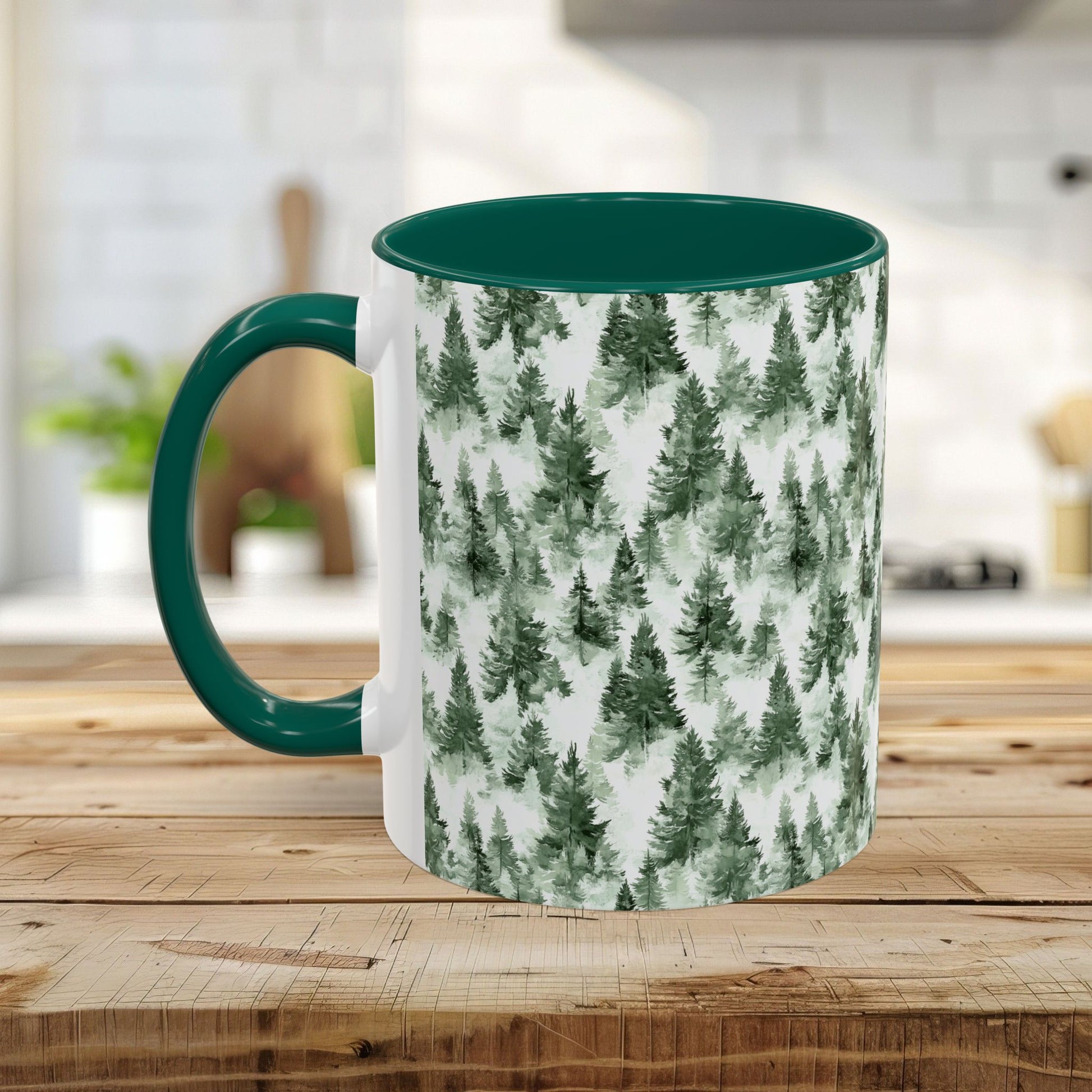 White ceramic mug with a watercolor evergreen forest pattern and a dark green handle and interior.
