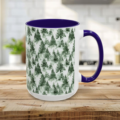 15oz ceramic mug with a navy handle and interior, featuring a watercolor evergreen forest design.