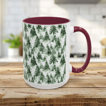 15oz ceramic mug with a watercolor evergreen forest pattern and a maroon handle and interior.