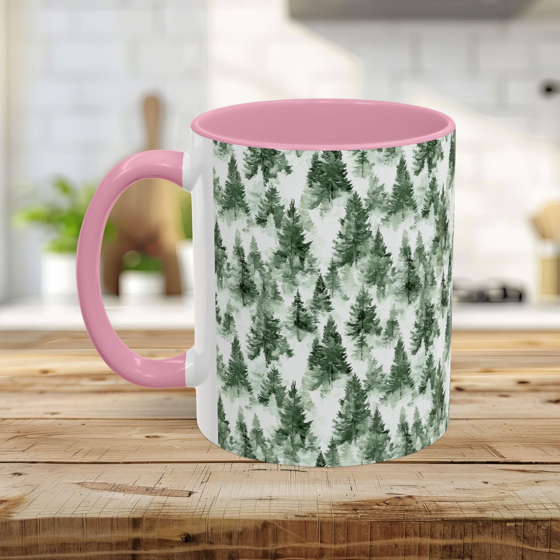 White ceramic mug with pink handle and interior, featuring a watercolor evergreen forest pattern.