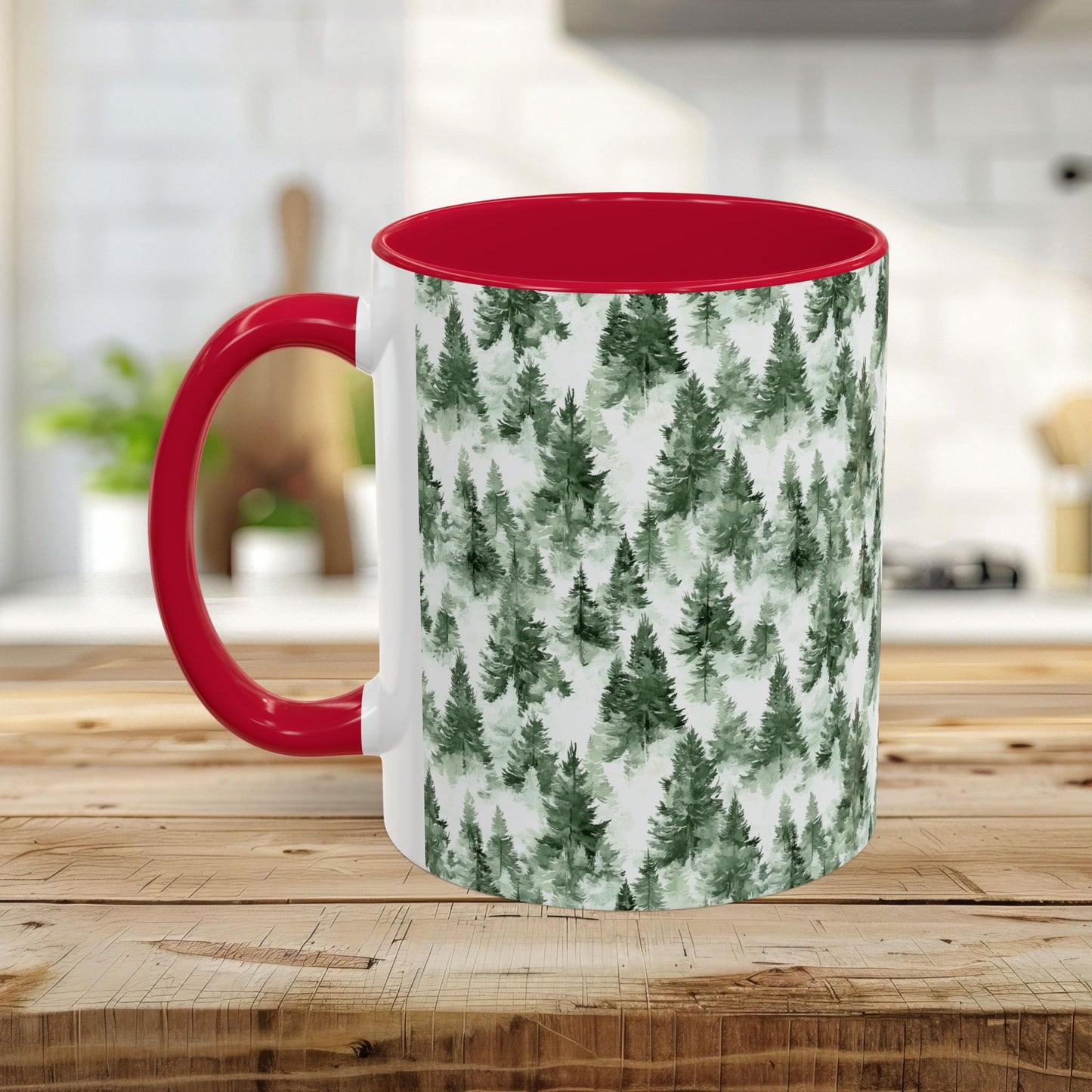 White ceramic mug with a red handle and interior, featuring a watercolor evergreen forest pattern.