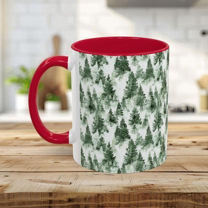 White ceramic mug with a red handle and interior, featuring a watercolor evergreen forest pattern.