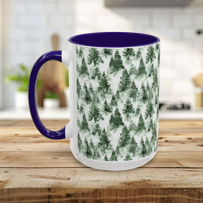 White ceramic mug with a watercolor evergreen forest pattern, purple handle, and interior.