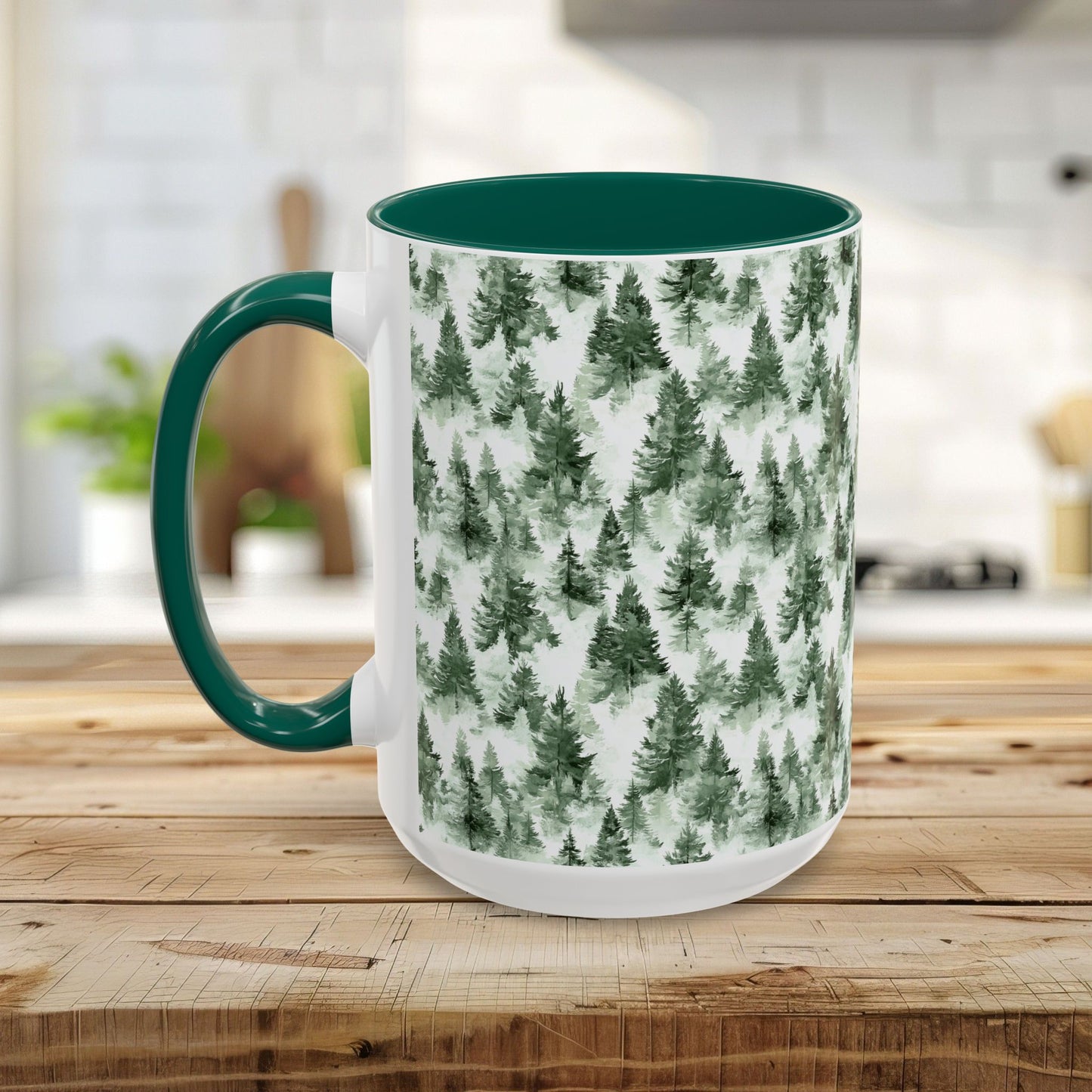 White ceramic mug with a green handle and interior, featuring a watercolor evergreen forest pattern.