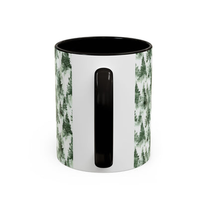White ceramic mug with black handle and interior, featuring a watercolor evergreen forest pattern.