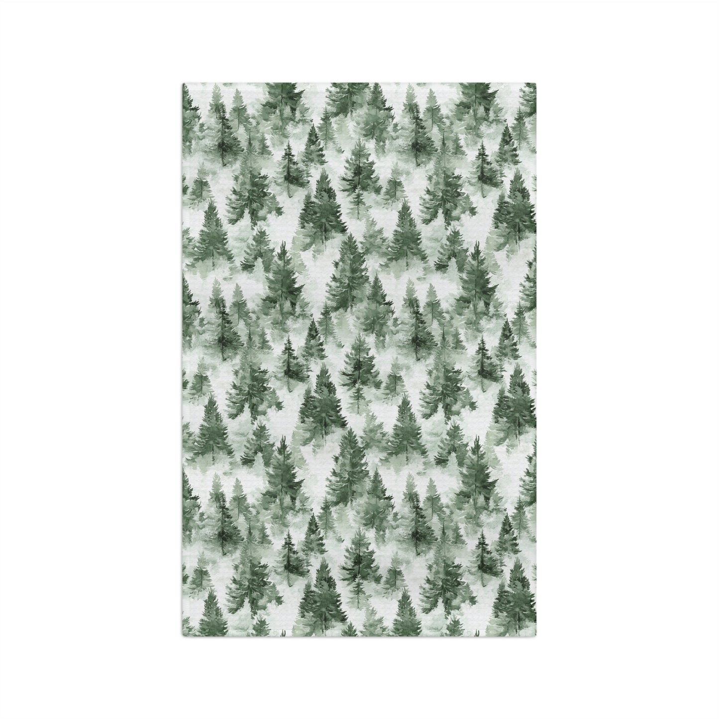 Microfiber tea towel with a painterly deep-green evergreen forest pattern on a white background.