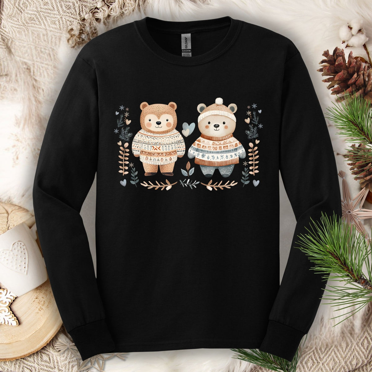 Black long-sleeve tee with two cute bears in Fair Isle sweaters, surrounded by winter foliage and snowflakes.