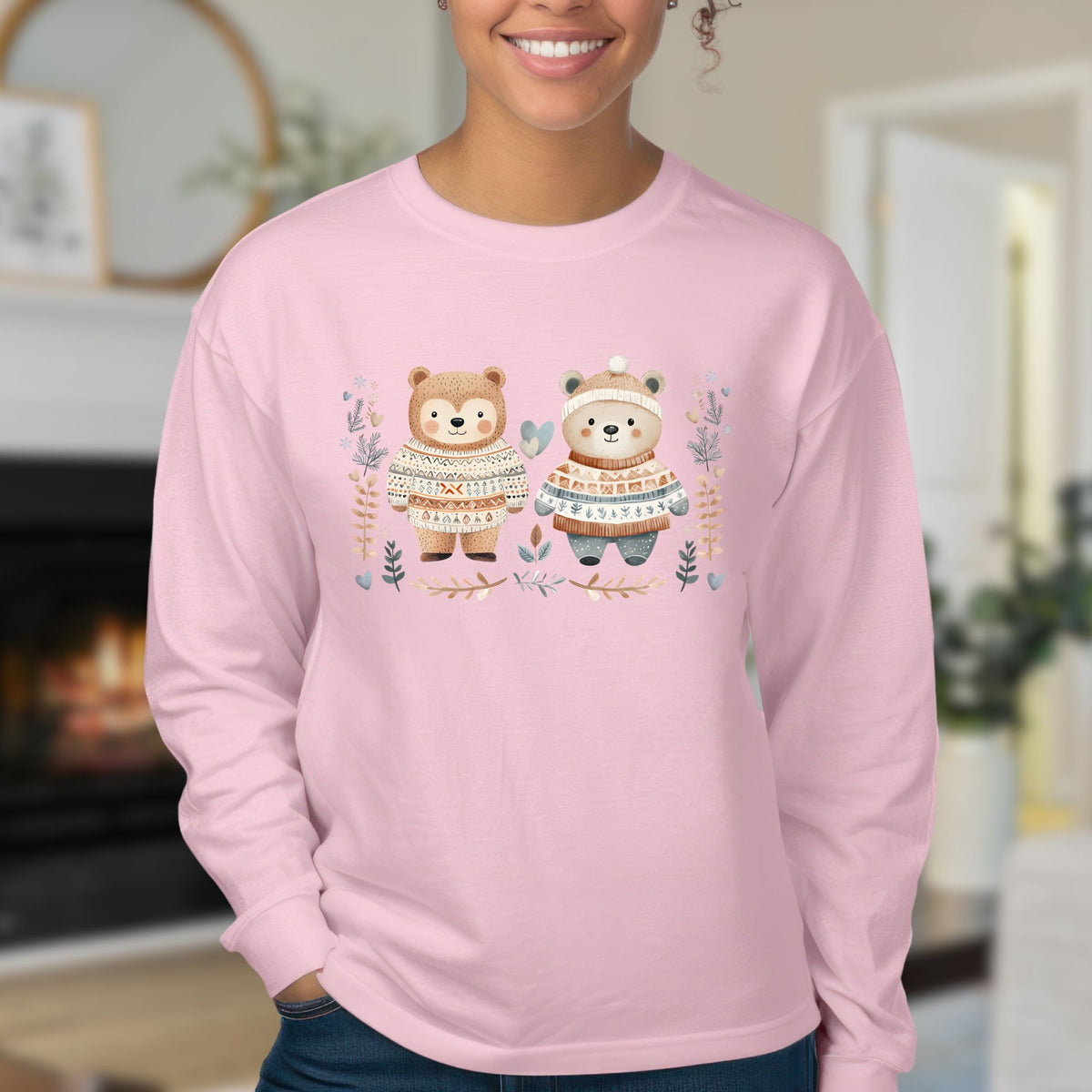 Pink long-sleeve tee with two watercolor bears in Fair Isle sweaters, winter foliage, and snowflakes.