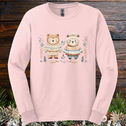 Light pink long-sleeve tee with two watercolor bears in Fair Isle sweaters, winter foliage, and snowflakes.