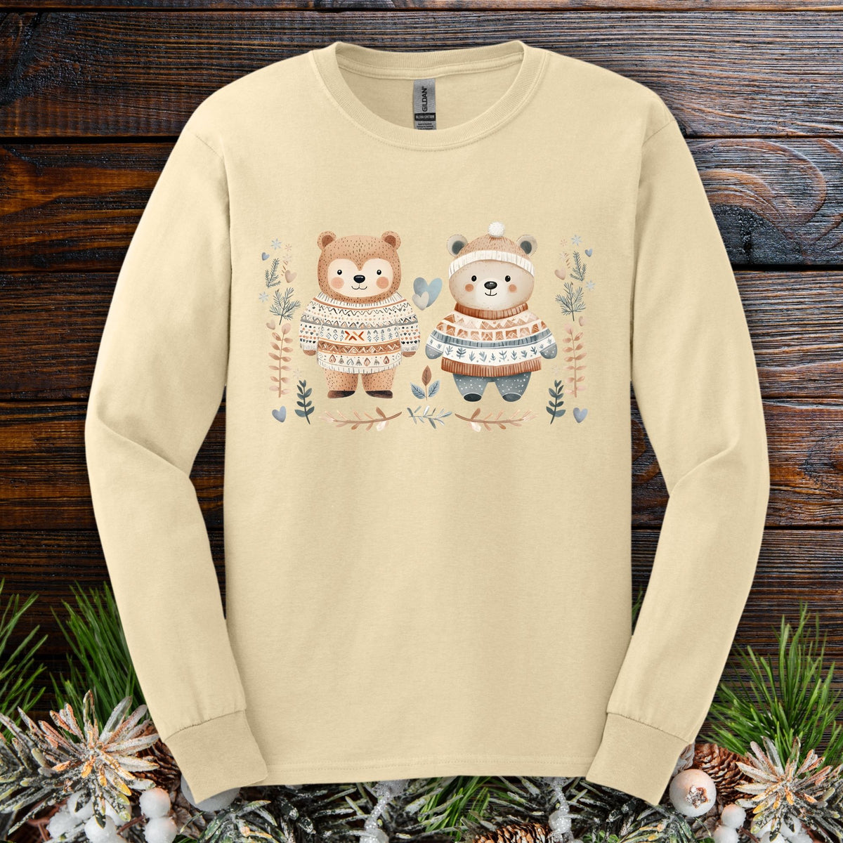 Sand S long-sleeve tee with two watercolor bears in Fair Isle sweaters, winter foliage, hearts, and snowflakes.