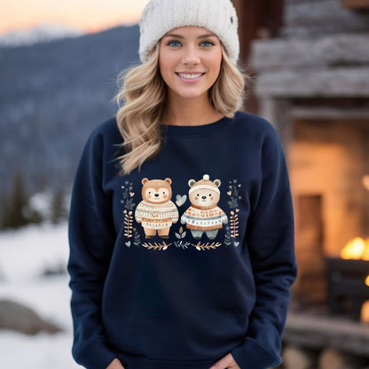 Woman in navy Fair Isle Love Bears sweatshirt with winter foliage, snowflakes, and hearts.