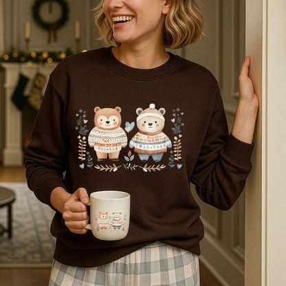 Woman in a brown Fair Isle Love Bears sweatshirt, holding a matching mug, with winter decor.