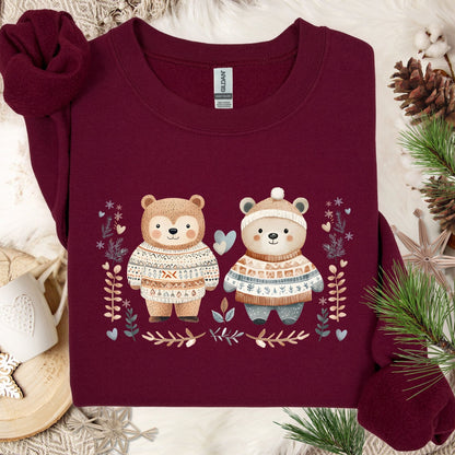 Maroon heavy blend sweatshirt with two love bears in Fair Isle sweaters, winter foliage, and snowflakes.